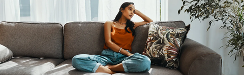 A woman is sitting relaxed on a sofa