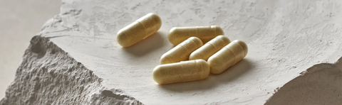 Capsules are lying on a light-colored stone