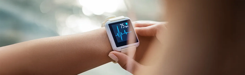 Close-up of a smartwatch on the wrist with a heart rate display