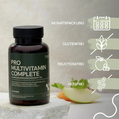 Pro Multivitamin Complete can in front of apple and carrot pieces; features: monthly supply, gluten-free, fructose-free, yeast-free