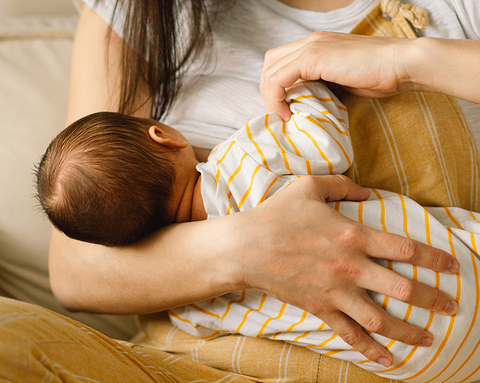 A mother is breastfeeding her baby