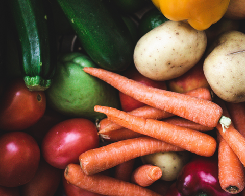 Colorful vegetables: carrots, potatoes, zucchini, tomatoes, and bell peppers