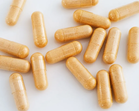 Many yellow capsules on a white background