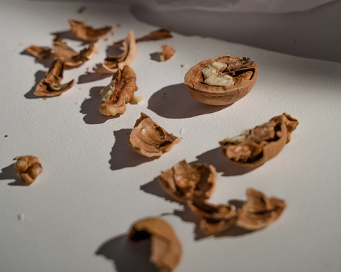 Cracked walnut shells on a light-colored table