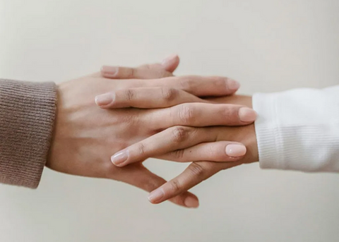 Two hands holding each other—a symbolic image representing personalized customer service