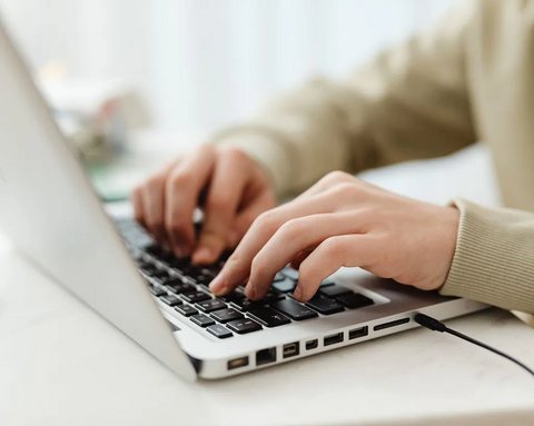 Hands typing on a laptop keyboard—illustrative image for the digital TISSO partner portal